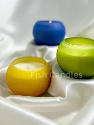 premium soy candle in colored jar Rolly Polly candle styled on soft draped curtain