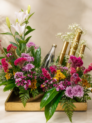 Customized drink bottle with white lilies, pink celosia, chrysanthemums, and decorative golden bamboo floral arrangement