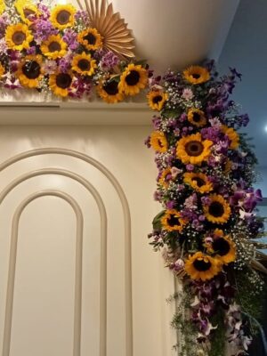 Elegant sunflower and purple orchid floral arrangement for entrance decoration
