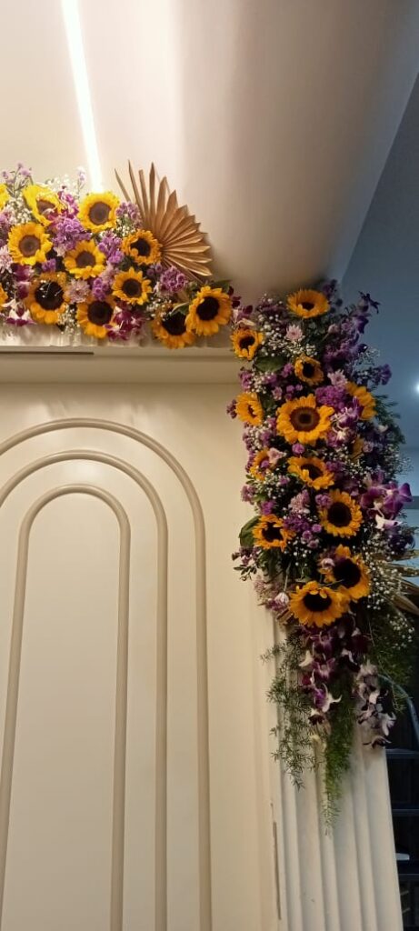 Elegant sunflower and purple orchid floral arrangement for entrance decoration