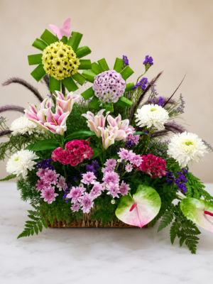 Fresh floral basket arrangement with pink lilies, white chrysanthemums, anthurium, statice and seasonal fillers
