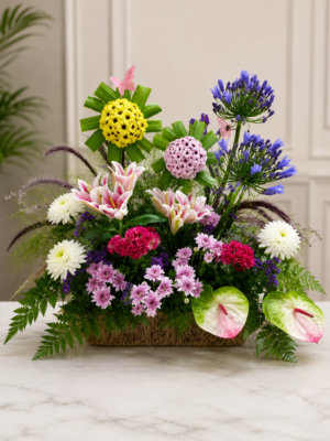 Elegant mixed flower basket with pink lilies, agapanthus, chrysanthemums and anthuriums