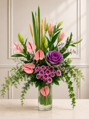Premium Pink Lily & Anthurium Floral Fresh flower arrangement featuring pink lilies, pink anthuriums, ornamental cabbage, purple chrysanthemums, cascading greenery, and seasonal foliage in a clear glass vase. Arrangement in Glass Vase