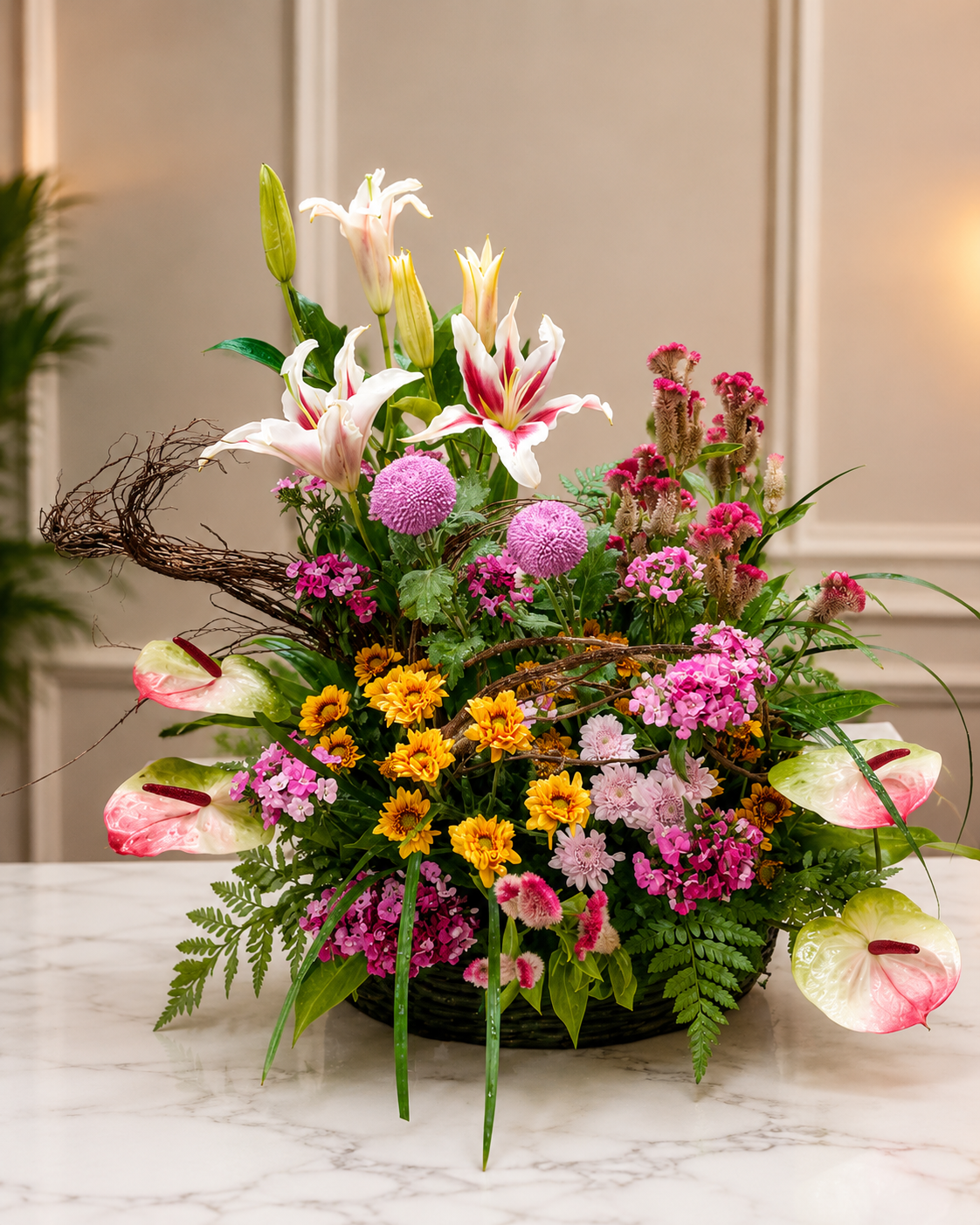 Colorful floral basket arrangement with white oriental lilies, pink anthuriums, yellow chrysanthemums, globe flowers, and seasonal fillers