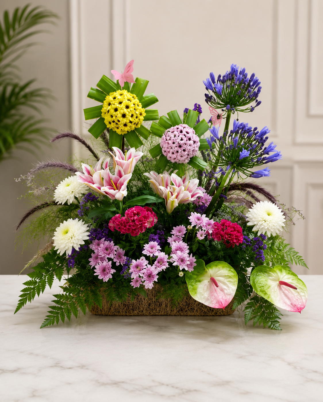 Elegant mixed flower basket with pink lilies, agapanthus, chrysanthemums and anthuriums