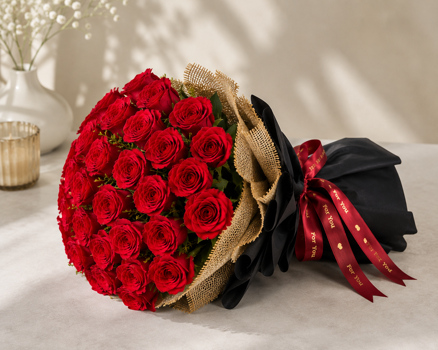 Premium fresh red roses bouquet with elegant black wrapping, burlap finish, and satin ribbon for romantic occasions in Mumbai