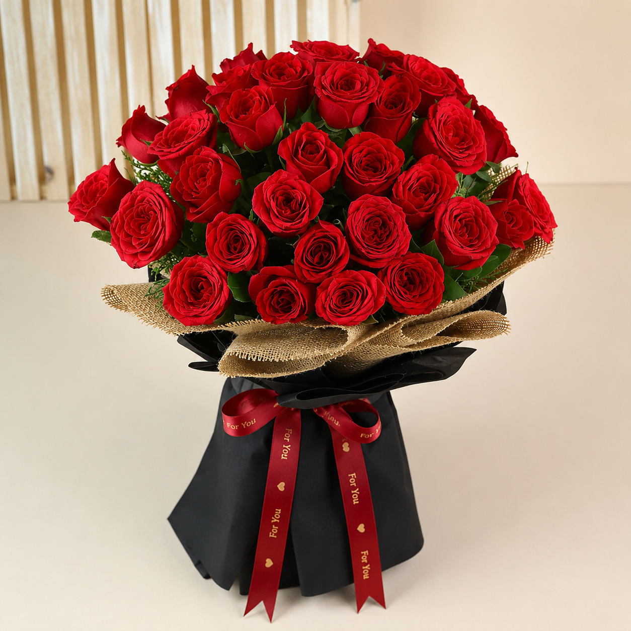 Premium fresh red roses bouquet with elegant black wrapping, burlap finish, and satin ribbon for romantic occasions in Mumbai
