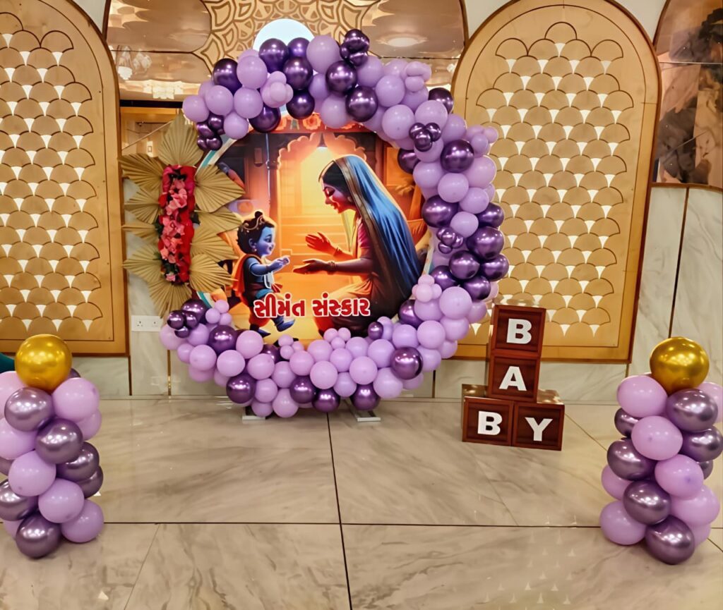 Seemant Sanskar baby shower decoration with purple and lavender balloon arch and mother and baby backdrop